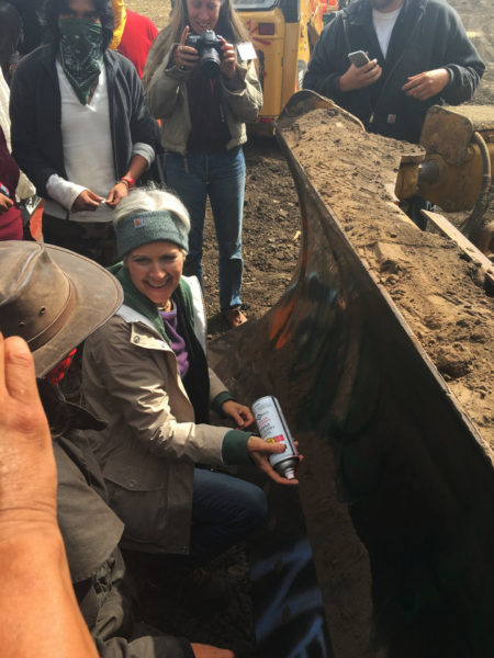 Green Party Presidential candidate, Jill Stein, prepares to spray paint on blade of bulldozer located on the Dakota Access Pipeline site